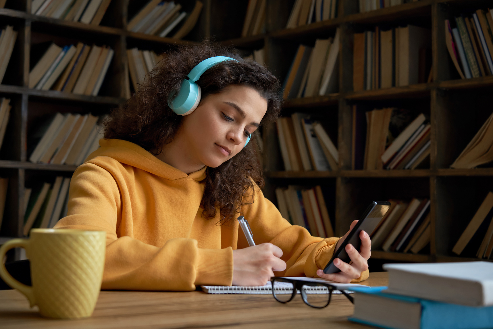 Teenage Girl Studying While Listening to Music 